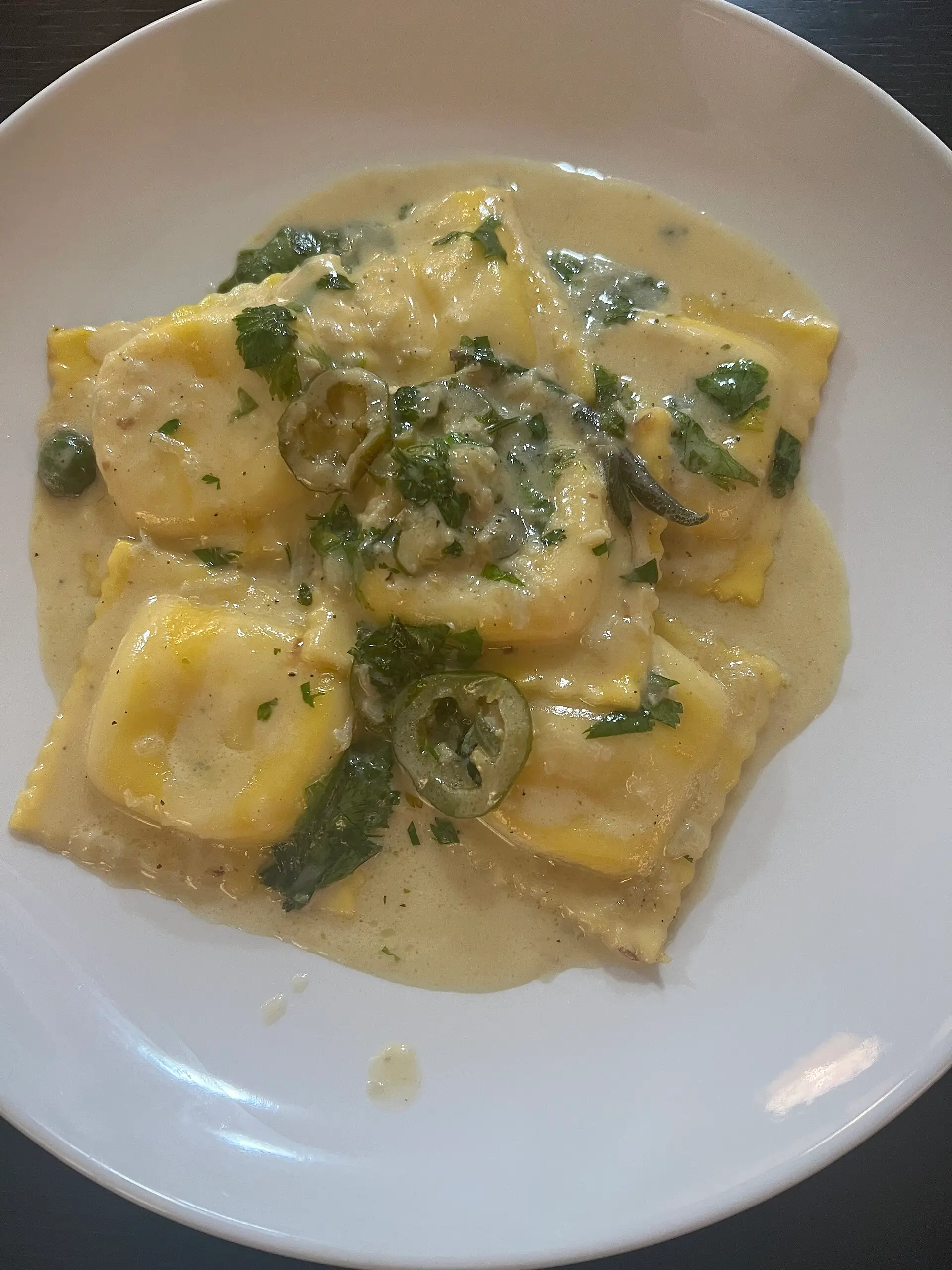 An Italian seafood pasta dish in a creamy butter-sage sauce, restaurant plating.