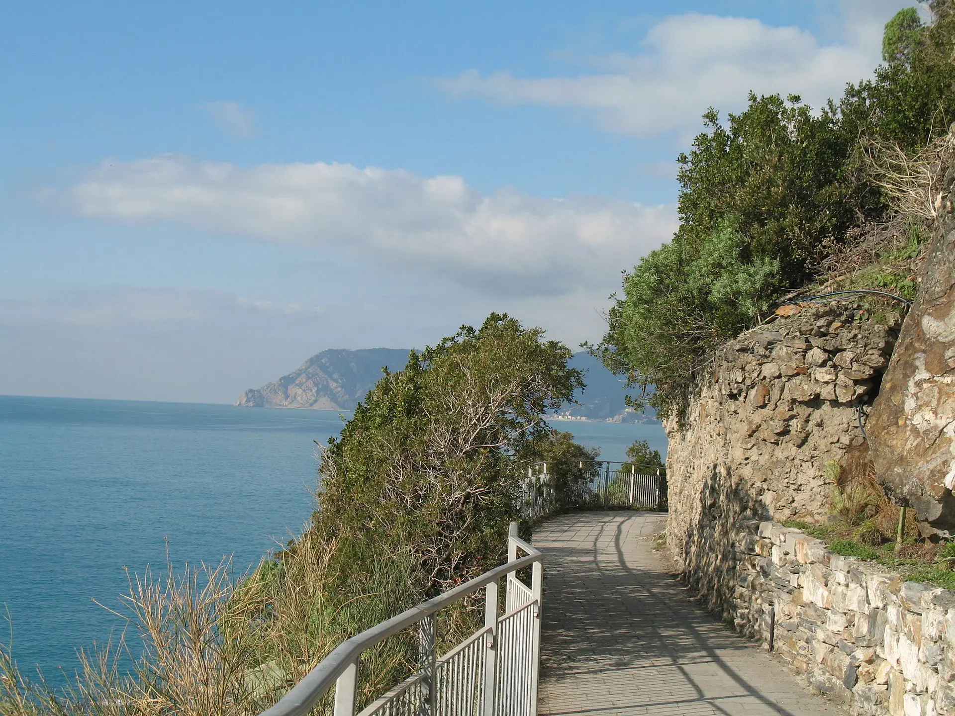 Via dell'Amore — the cliff path between Riomaggiore and Manarola, paved walkway hugging the coast above the sea.
