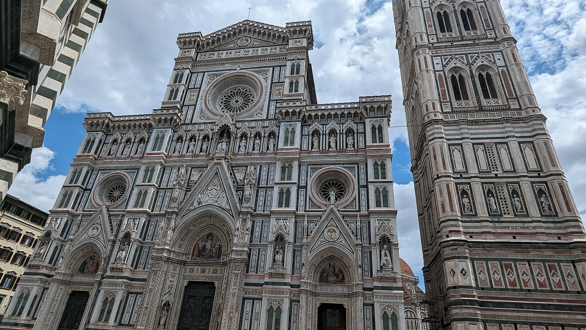 The marble Gothic facade of the Cattedrale di Santa Maria del Fiore in Florence, with Giotto's Campanile rising at right.