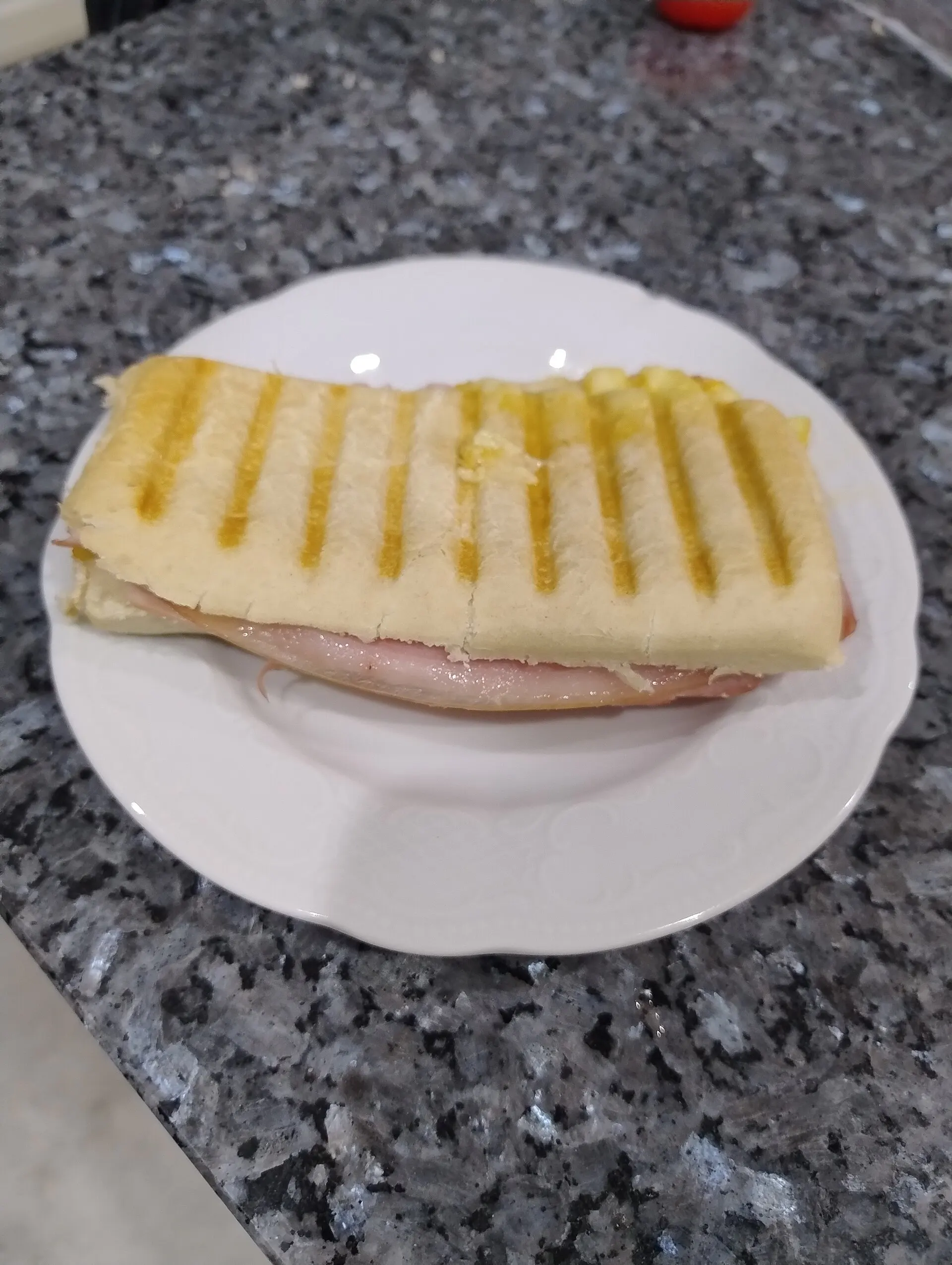 A grilled Italian panini sandwich — the kind Pino's serves.