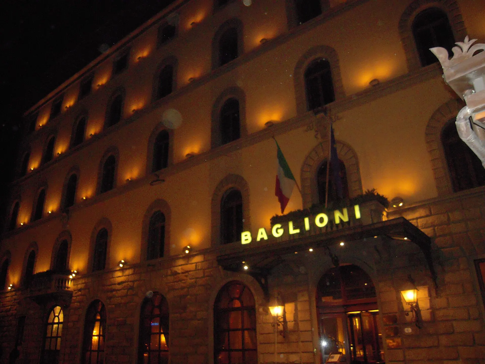 Hotel Baglioni in Florence — the warm-lit facade with the Italian flag, home to the Loggia rooftop bar.